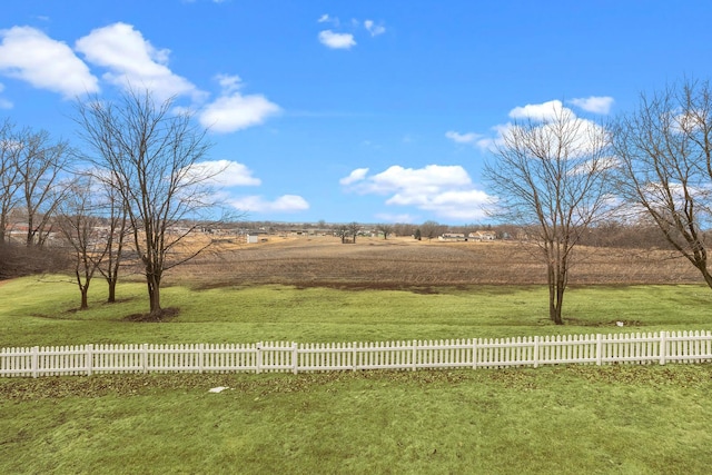 view of yard featuring fence and a rural view