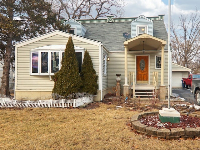 view of front of property with a garage, a front yard, roof with shingles, and a chimney