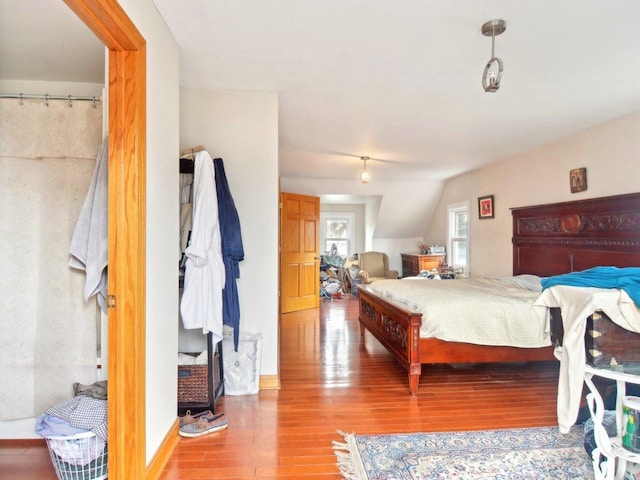 bedroom featuring vaulted ceiling and wood finished floors