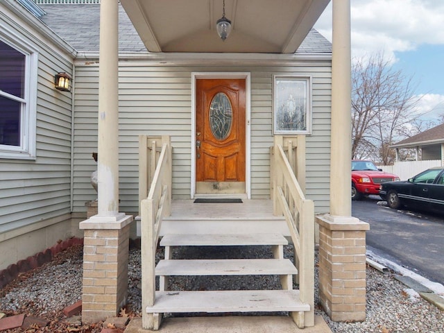 property entrance with roof with shingles