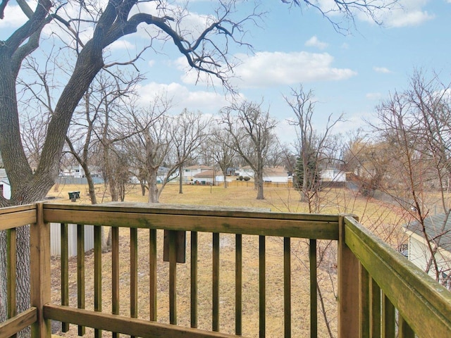 wooden deck featuring a lawn