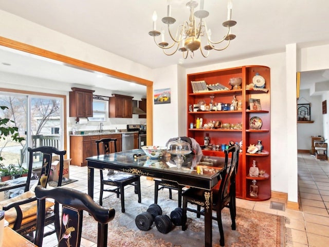 dining area featuring light tile patterned flooring, a notable chandelier, visible vents, and baseboards