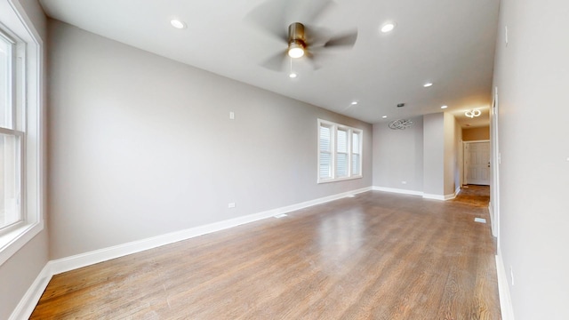 spare room featuring light wood-style floors, recessed lighting, baseboards, and a ceiling fan