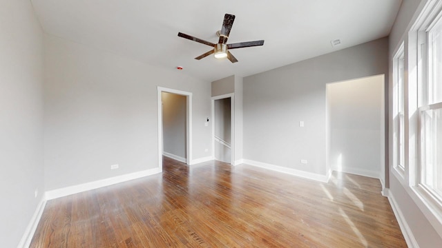 unfurnished room featuring baseboards, ceiling fan, and light wood finished floors