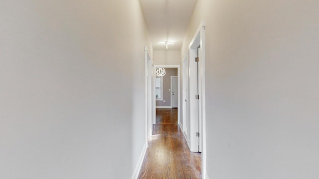 hall featuring baseboards and wood finished floors