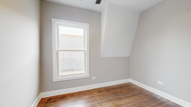 interior space featuring dark wood-style flooring and baseboards