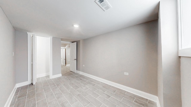 spare room featuring baseboards and visible vents