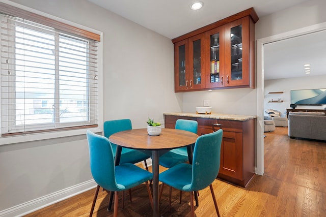 dining room with recessed lighting, baseboards, and light wood finished floors