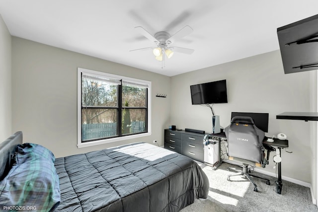 bedroom with light carpet, baseboards, and a ceiling fan