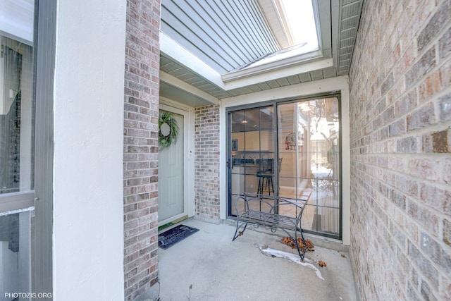 property entrance featuring brick siding