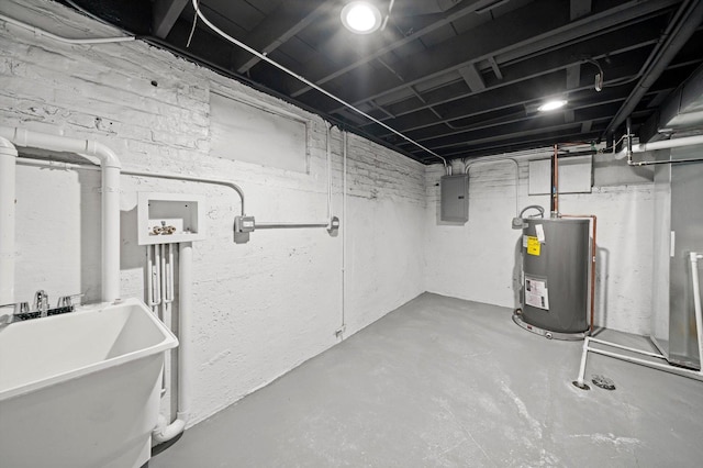 unfinished basement featuring electric panel, water heater, and a sink