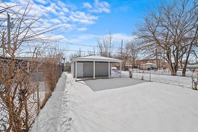 snowy yard featuring fence