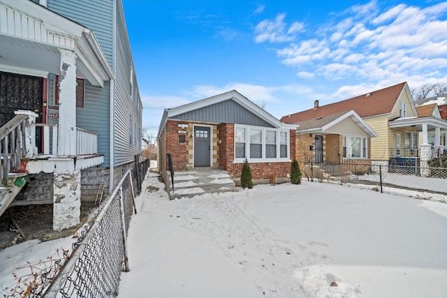 view of front of property with brick siding and fence