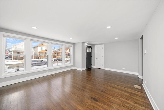 interior space with dark wood-style flooring, recessed lighting, visible vents, and baseboards