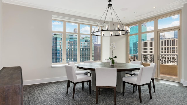 dining room featuring ornamental molding, a view of city, a healthy amount of sunlight, and baseboards