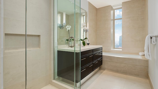 full bathroom with double vanity, a stall shower, tile patterned flooring, and a bath