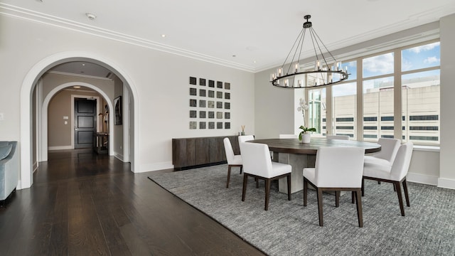 dining area featuring arched walkways, ornamental molding, dark wood-style flooring, and baseboards