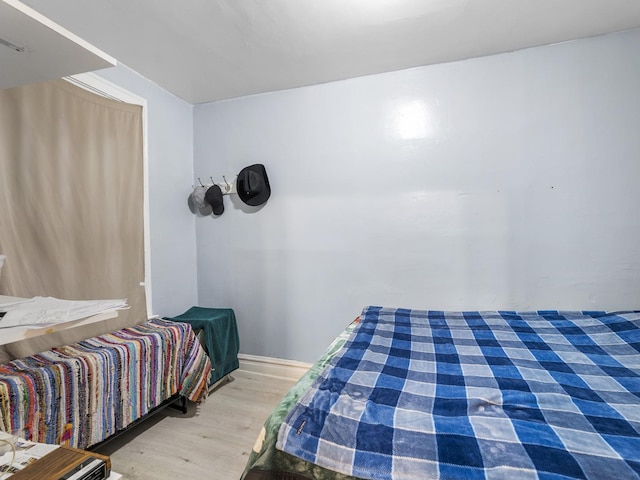 bedroom featuring wood finished floors