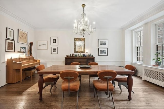 dining space with a chandelier, radiator, dark wood-style flooring, and crown molding