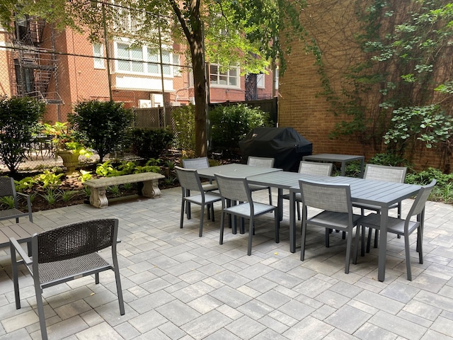 view of patio / terrace featuring outdoor dining space, grilling area, and fence