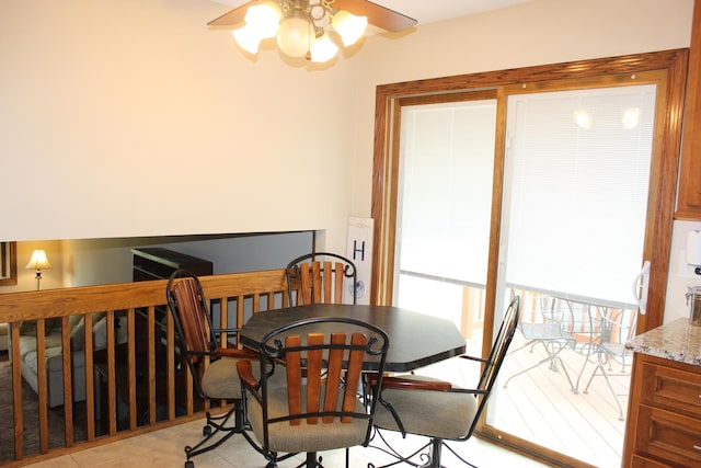 dining room featuring a ceiling fan and stairs