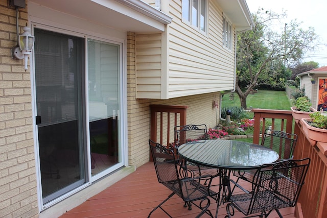 wooden terrace with outdoor dining space