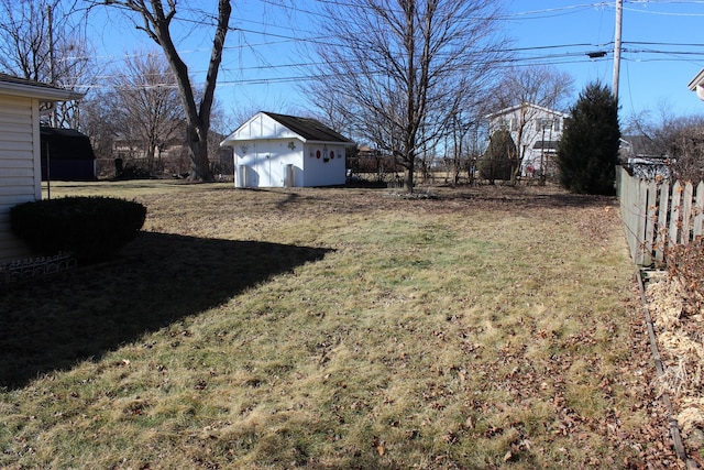 view of yard featuring fence and an outdoor structure