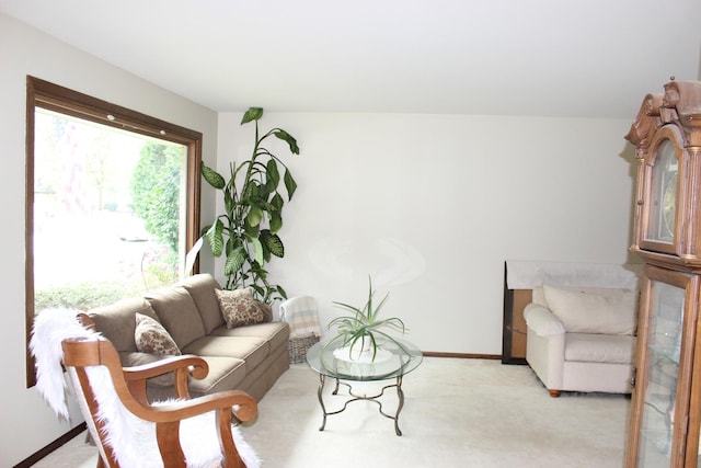 living room featuring light carpet and baseboards