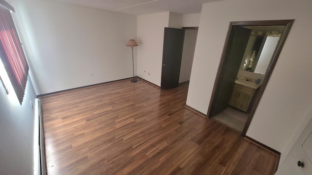 unfurnished bedroom with baseboards and wood finished floors