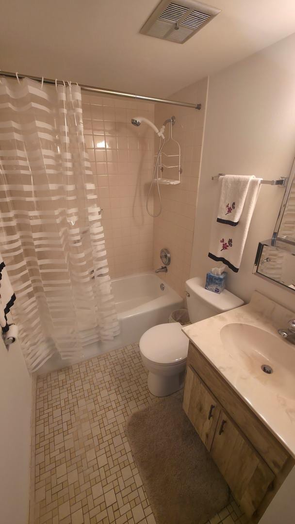 full bath featuring toilet, vanity, visible vents, tile patterned floors, and shower / bath combination with curtain