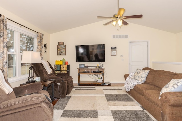 living area with baseboards, visible vents, vaulted ceiling, and a ceiling fan