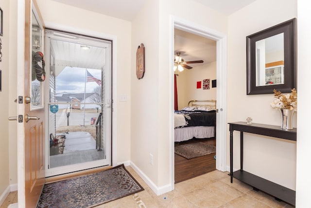 interior space featuring ceiling fan and baseboards