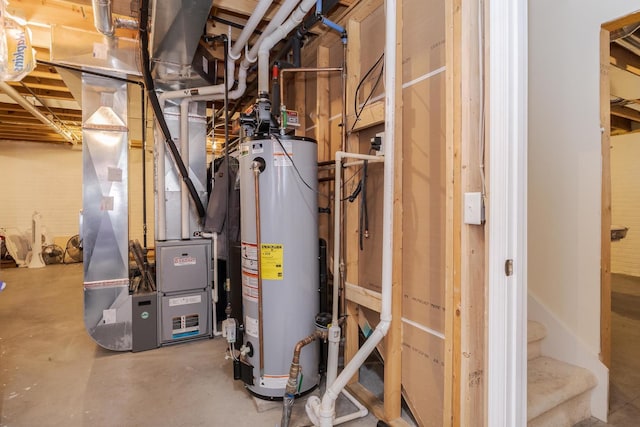 utility room with heating unit and gas water heater