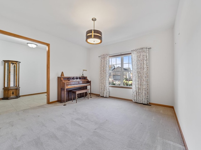 living area with light colored carpet and baseboards