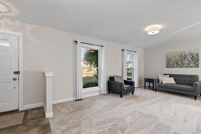 sitting room featuring carpet flooring, visible vents, and baseboards