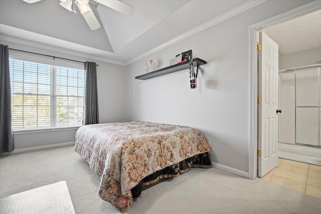 carpeted bedroom featuring crown molding, a raised ceiling, ceiling fan, baseboards, and tile patterned floors