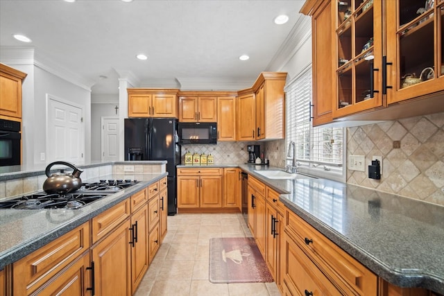 kitchen with light tile patterned floors, black appliances, ornamental molding, and a sink