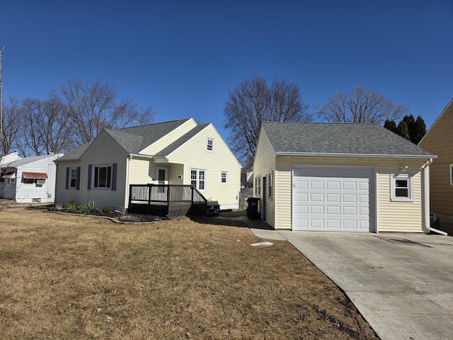 view of property exterior featuring a garage, driveway, a shingled roof, a lawn, and a wooden deck