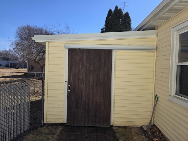 view of outbuilding featuring fence