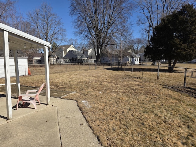 view of yard with a residential view, a patio area, and fence