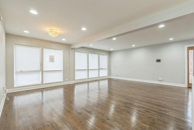 spare room with recessed lighting, dark wood-style flooring, and baseboards