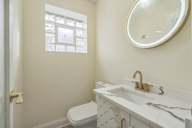 half bathroom with toilet and vanity