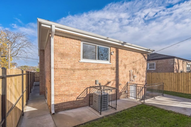 back of property with a patio area, a fenced backyard, and brick siding