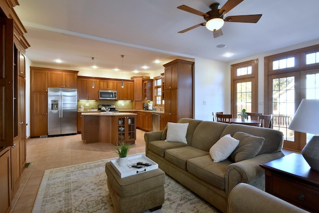 living area with recessed lighting, ceiling fan, and light tile patterned flooring