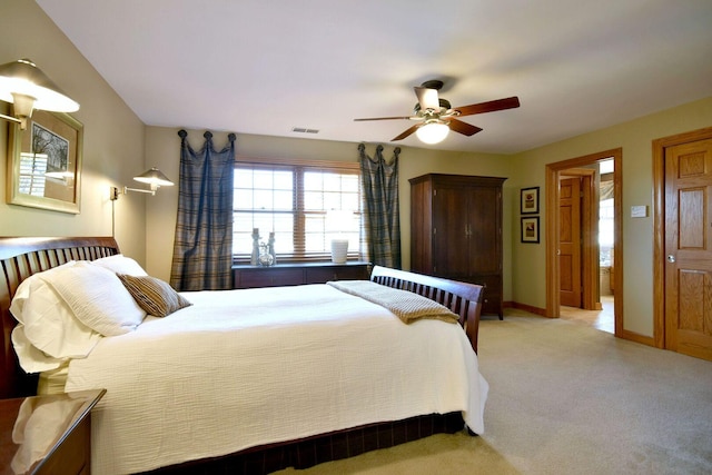 bedroom featuring visible vents, ceiling fan, light carpet, and baseboards