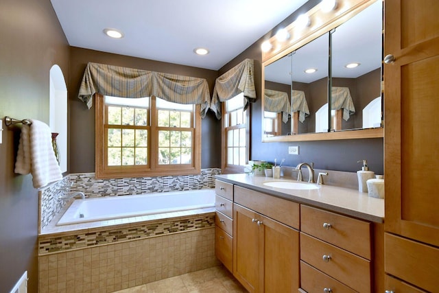 bathroom featuring tile patterned flooring, vanity, recessed lighting, and a bath