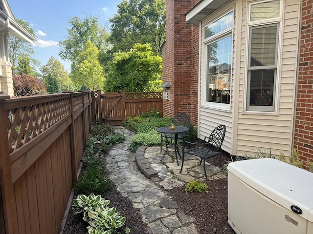 view of patio with fence and a gate