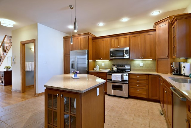 kitchen featuring brown cabinets, light tile patterned floors, tasteful backsplash, and stainless steel appliances