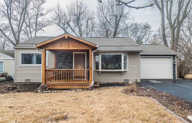 view of front of house with an attached garage, covered porch, a shingled roof, driveway, and crawl space