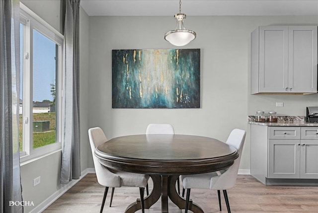 dining room featuring light wood-style floors and baseboards